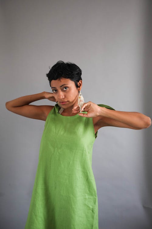 Woman in a Green Sleeveless Dress Looking at the Camera