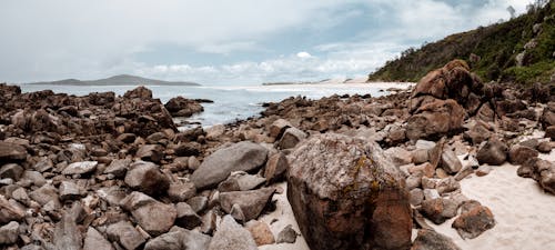 Free Brown and Gray Rocks Near Body of Water Stock Photo