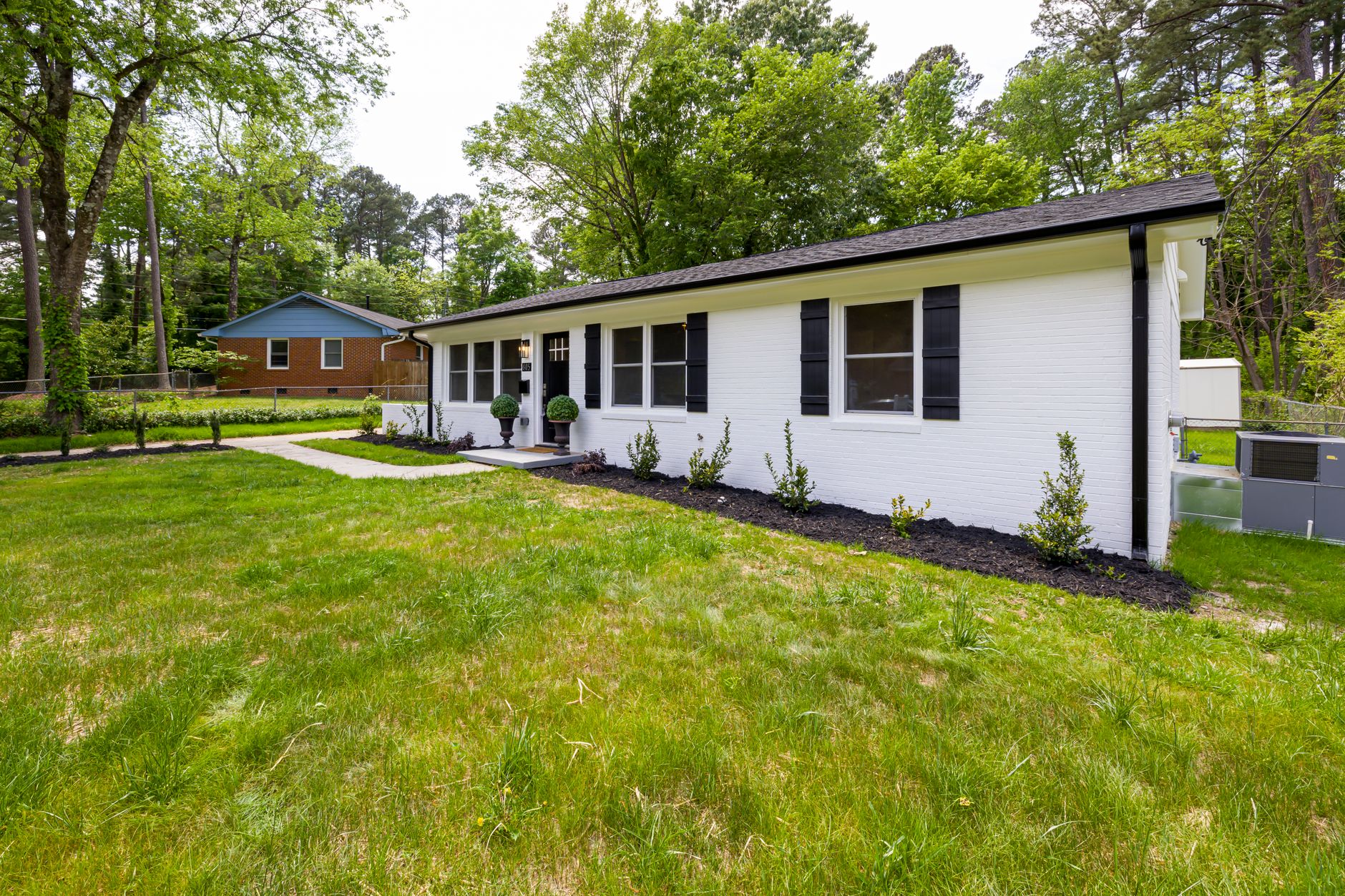 Modern suburban home with lush green lawn and landscaped garden in Cambridge, Ontario spring renovation. Modern suburban home with lush green lawn and landscaped garden in Cambridge, Ontario spring renovation.