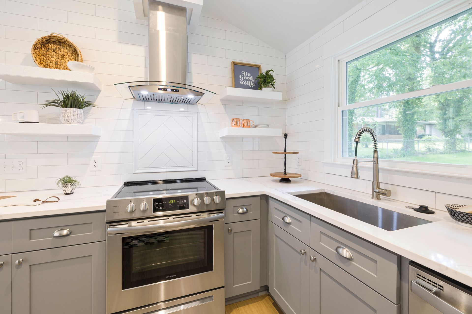 A modern kitchen boasting stainless steel appliances, open shelving, and elegant countertops.
