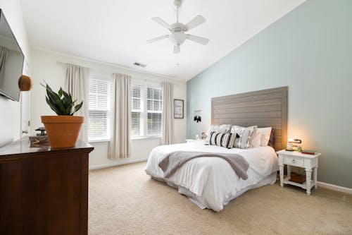 A Contemporary Bedroom with White and Blue Painting