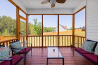 An  Enclosed Wooden Porch with Red and Blue Cushions