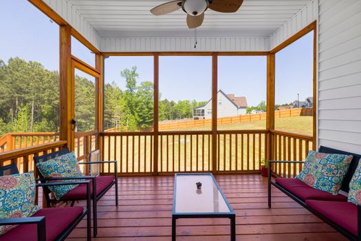 An  Enclosed Wooden Porch with Red and Blue Cushions