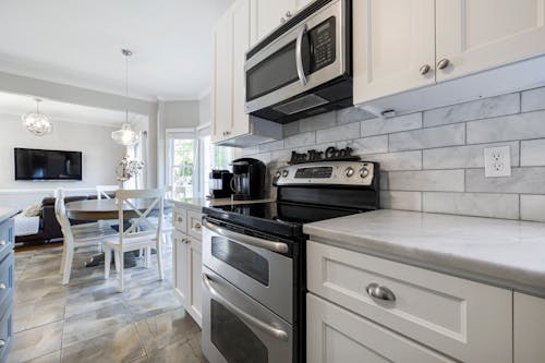 A Black and White Themed Kitchen with Marble Finish