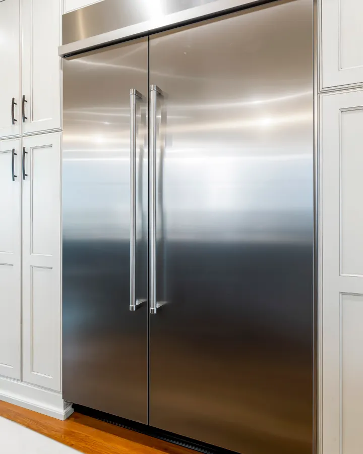 Sealed System & Refrigerant Recharge in La Mesa, CA Stainless steel refrigerator between wood cabinets needing sealed system and refrigerant repair in La Mesa