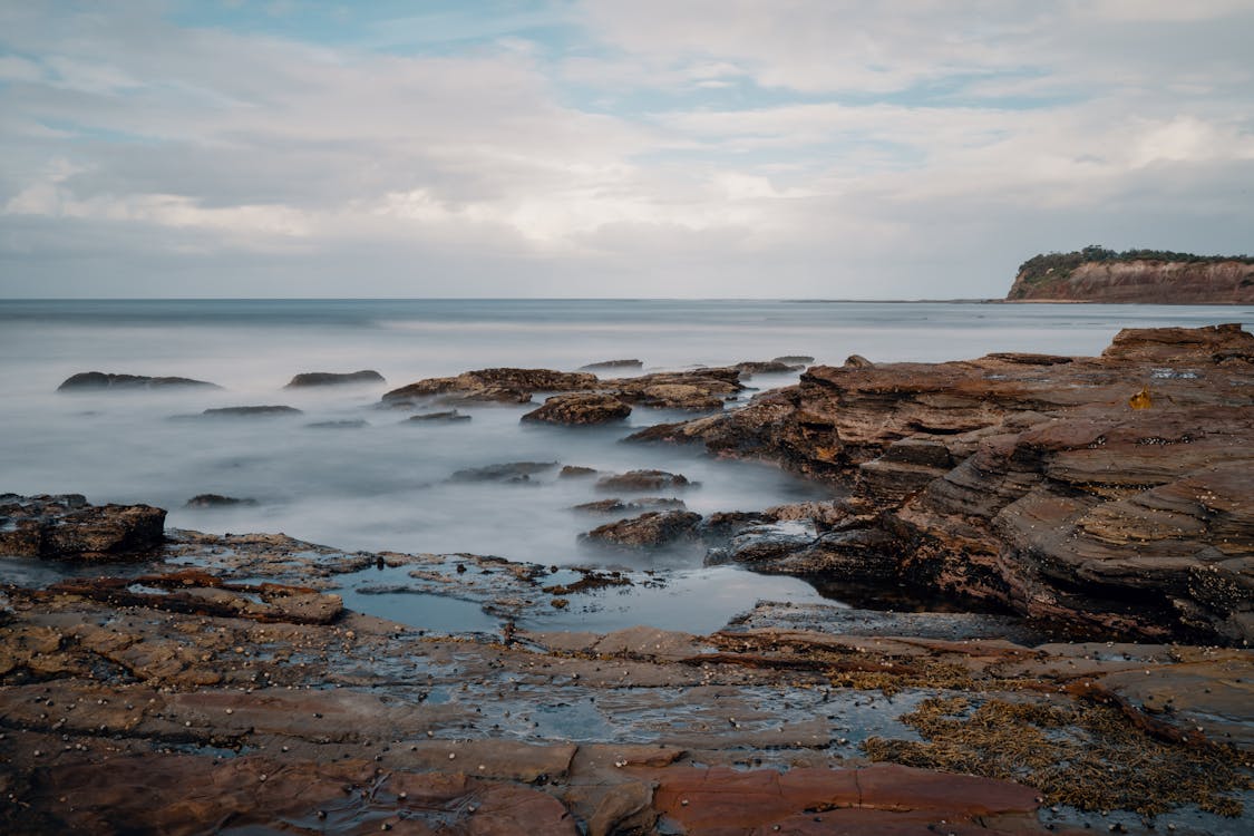 Brown Rocky Shore near Body of Water