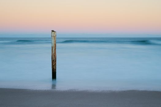 Peaceful and minimalistic beach scene with gentle waves and pastel skies in Sydney.