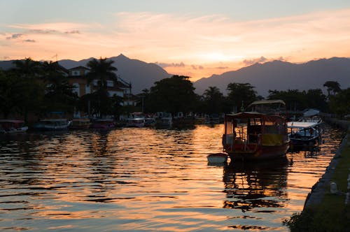 Boats on Water During Sunset