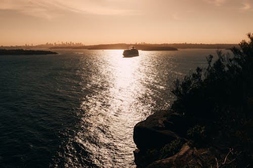 Silhouette of Cruise Ship on Water During Sunset