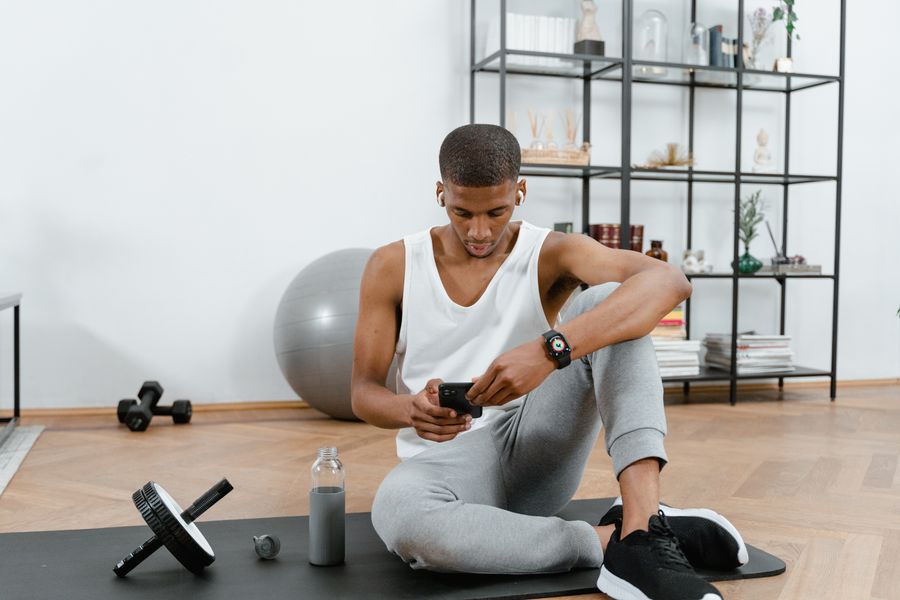 A coach following a workout program on a phone — photo by MART PRODUCTION on Pexels