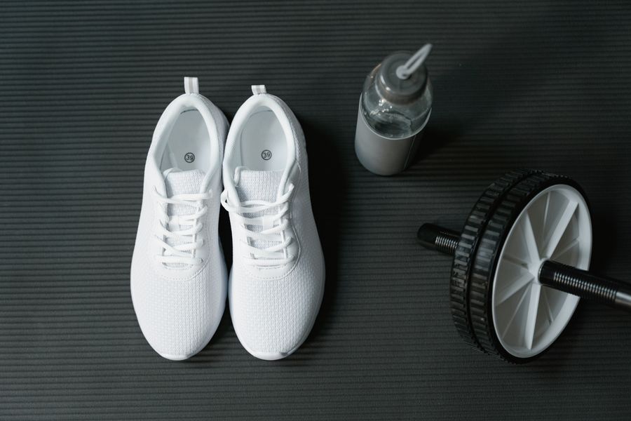 White training shoes on a gym mat