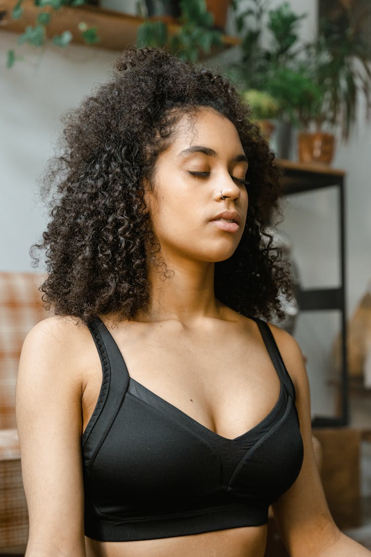 Woman In Black Sports Bra Meditating