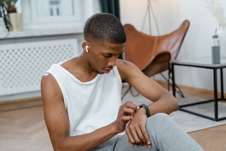 Man Wearing An Airpods And Smartwatch