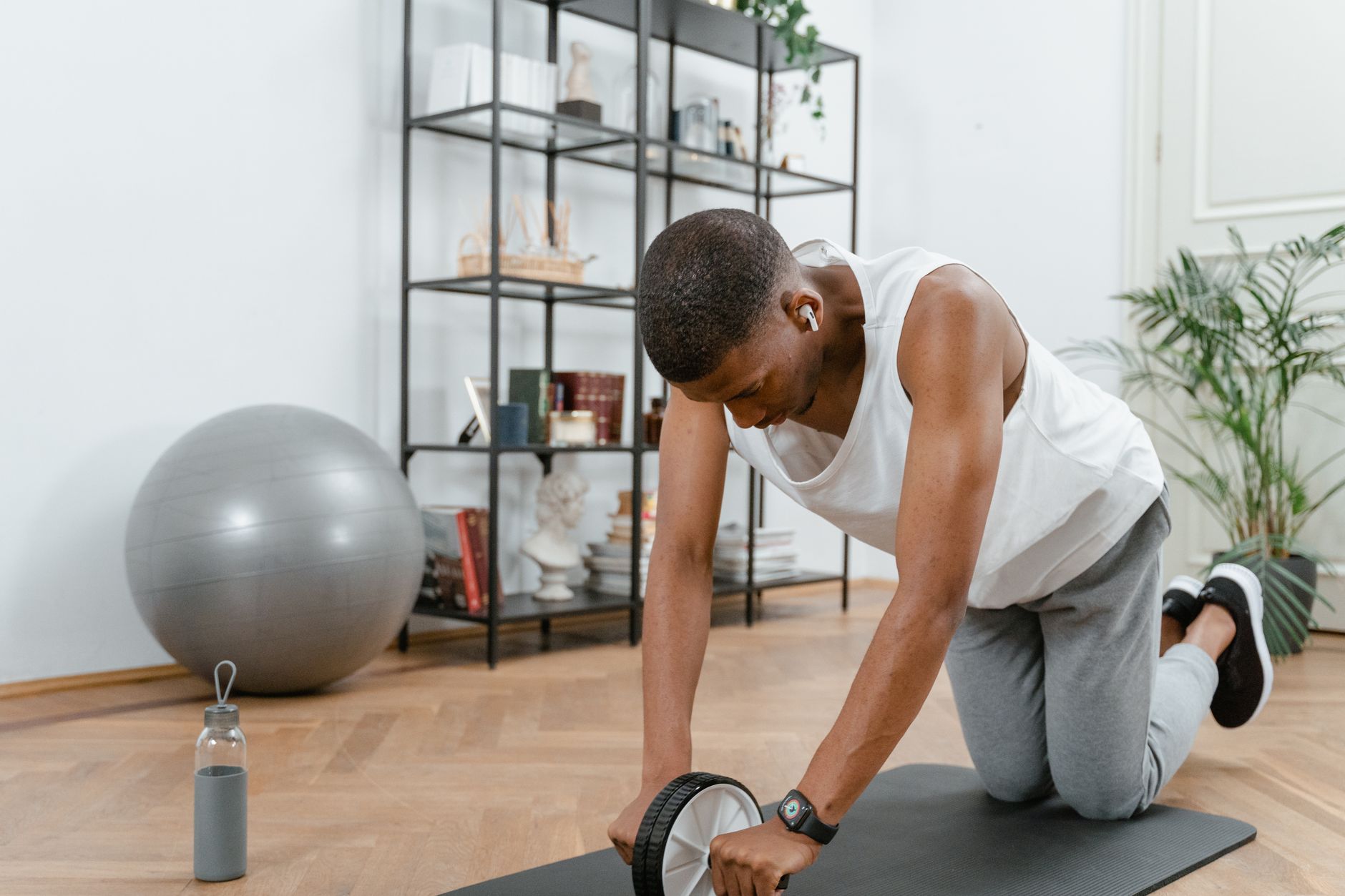 The 30 Day Strength Plan for Men Who Hate Complicated Workouts 1 Man using an ab wheel at home
