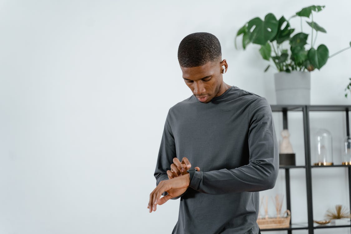 Man in Long Sleeve Shirt Looking at His Wristwatch