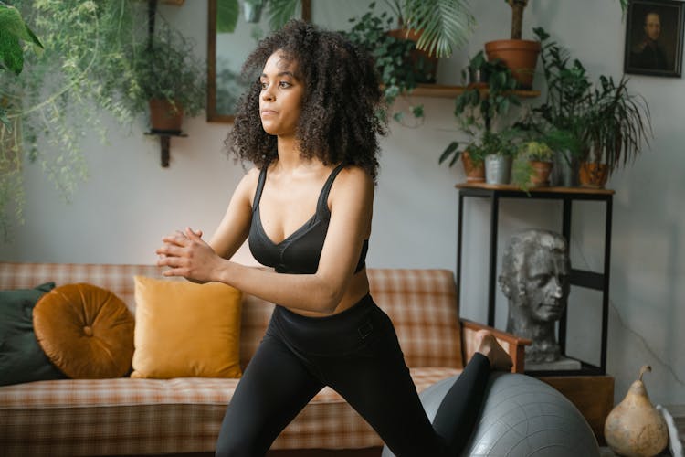 A Woman With Curly Hair Doing Exercise 