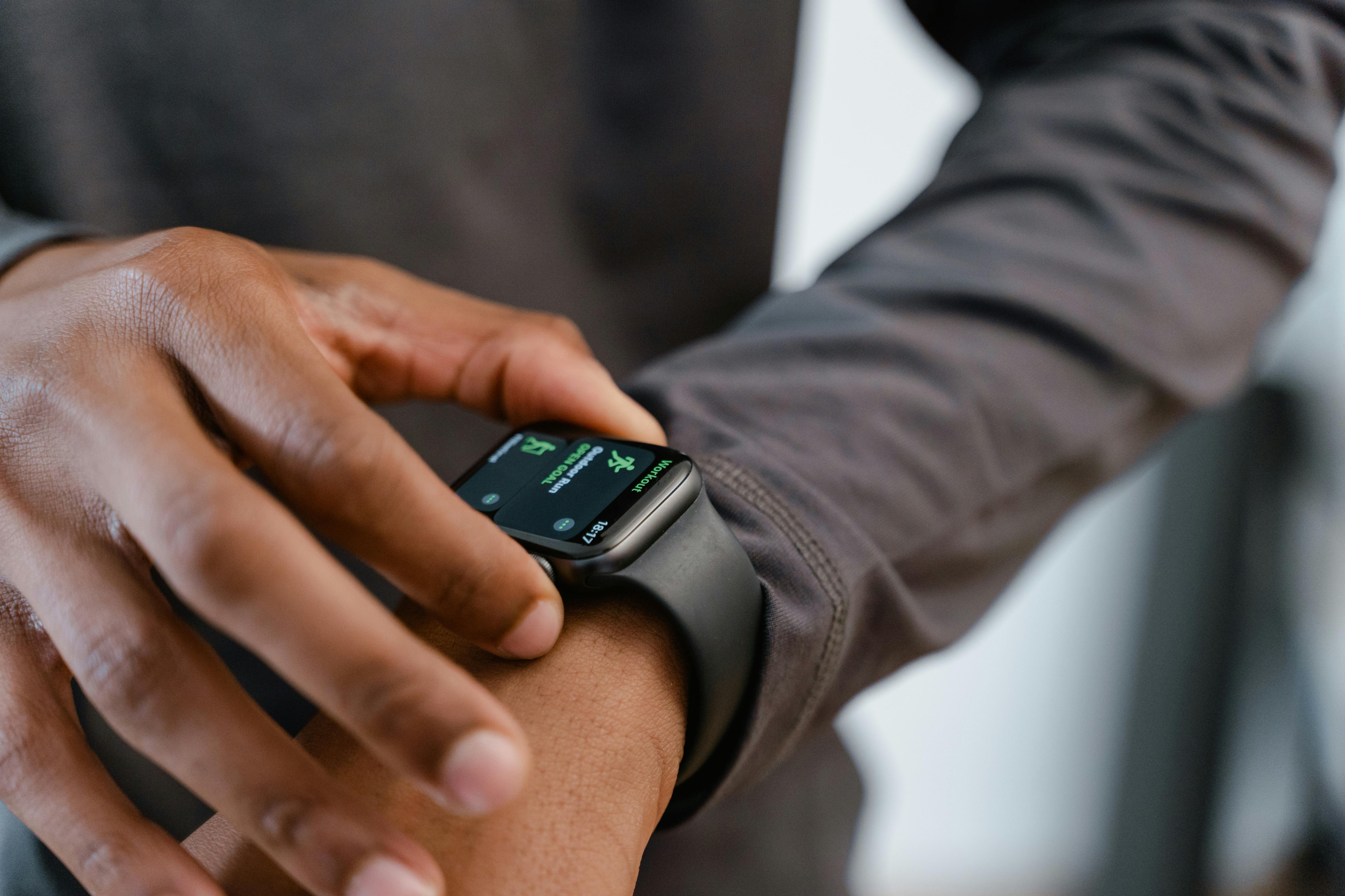 Free A detailed view of a smartwatch tracking fitness on a person's wrist. Stock Photo