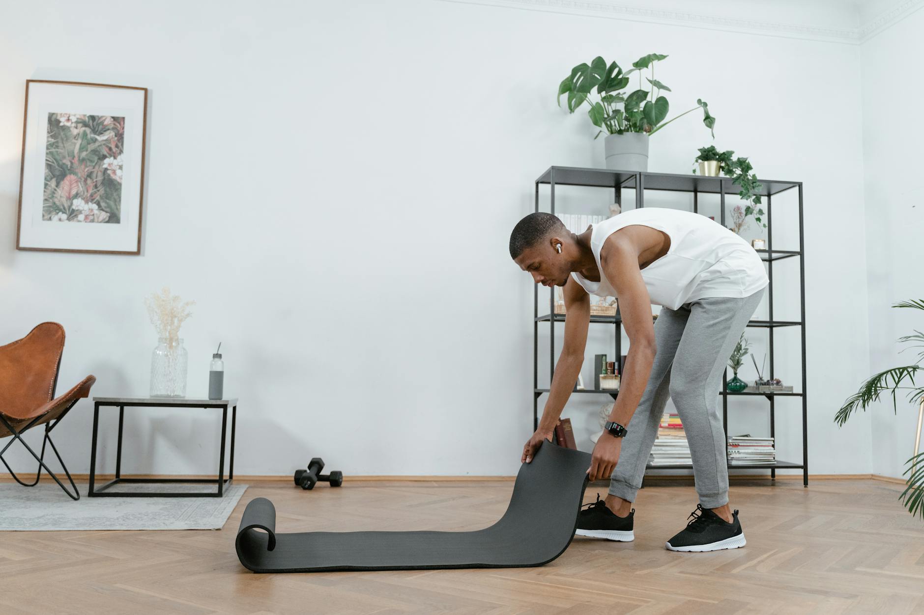 https://www.pexels.com/photo/a-man-holding-an-exercise-mat-8032957/