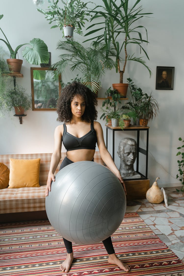 A Woman Holding A Stability Ball 