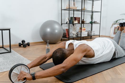 A man performs an ab roller workout indoors, emphasizing healthy lifestyle and fitness.
