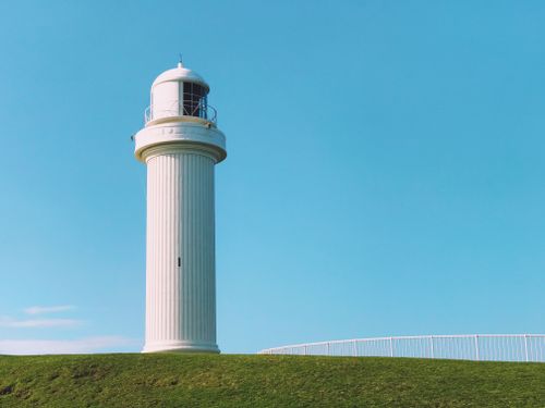 Free Minimalist view of Flagstaff Point Lighthouse in Wollongong under a clear blue sky. Stock Photo