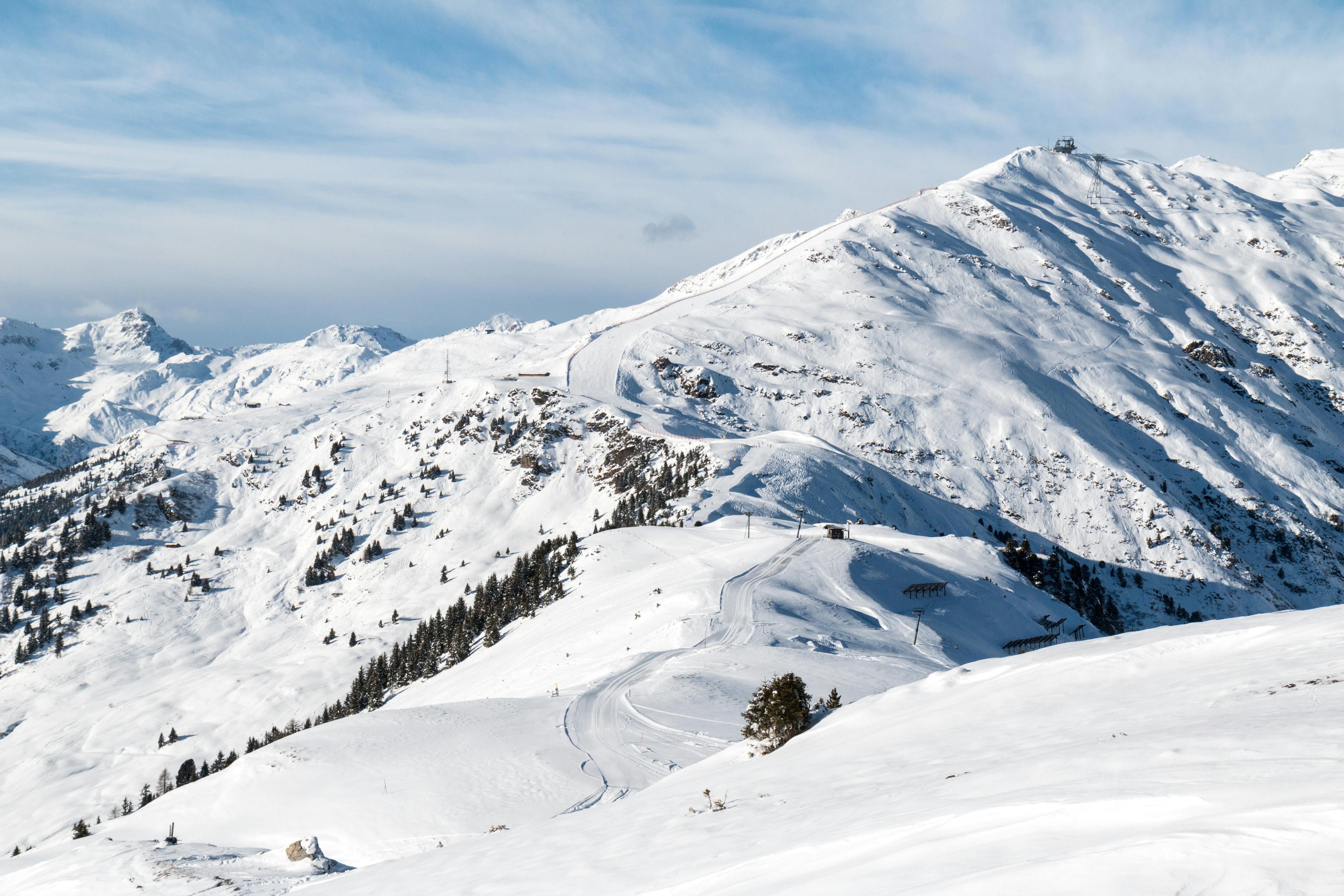 Prescription Goggle Inserts - Breathtaking view of a snow-covered mountain range under a clear blue sky, offering a serene winter landscape.