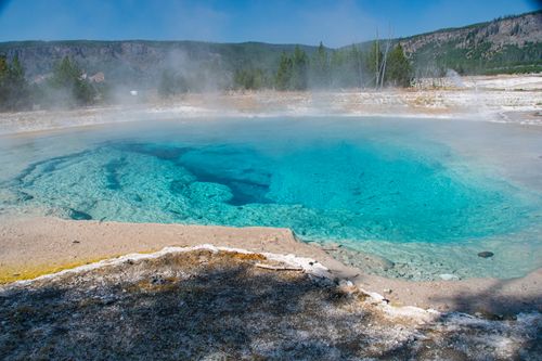 Free Stunning view of a vibrant turquoise hot spring with steam rising in Yellowstone National Park. Stock Photo