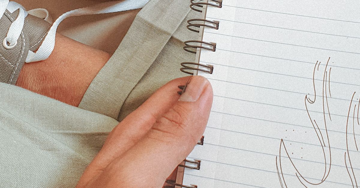 Hand of a Person Holding a Note Pad · Free Stock Photo