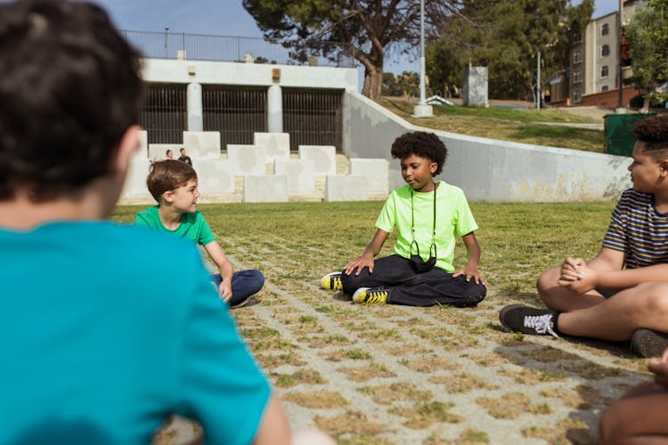 Group On Children Sitting On Grass