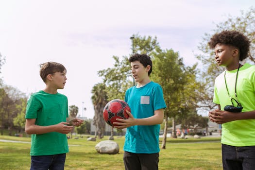 Three children enjoying a sunny day playing with a soccer ball in the park, fostering friendship and diversity.