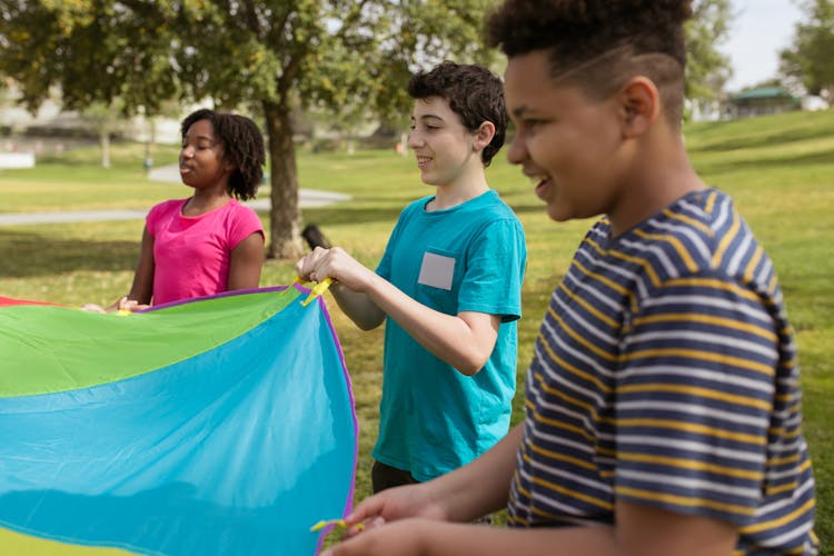 Children Playing A Parachute Game