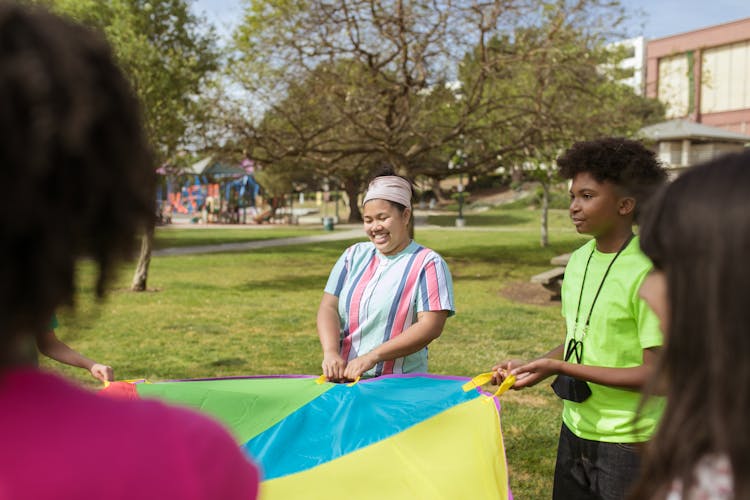 Children Playing A Parachute Game