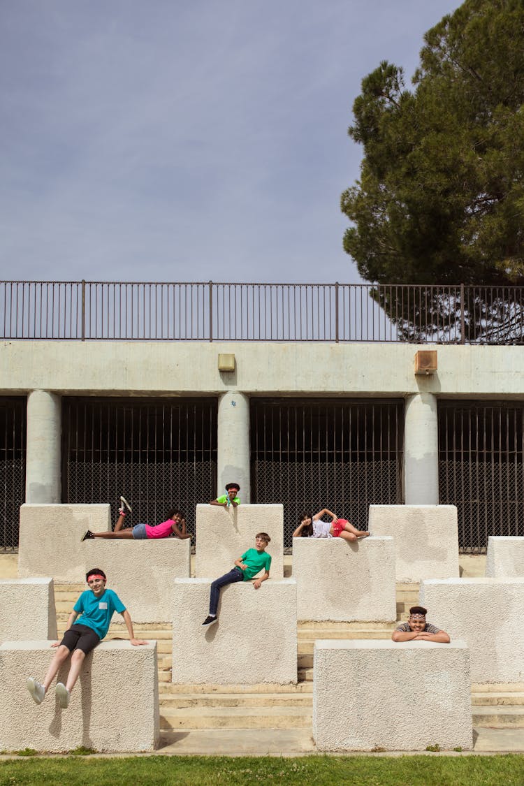 A Group Of Kids Posing On A Concrete Walls