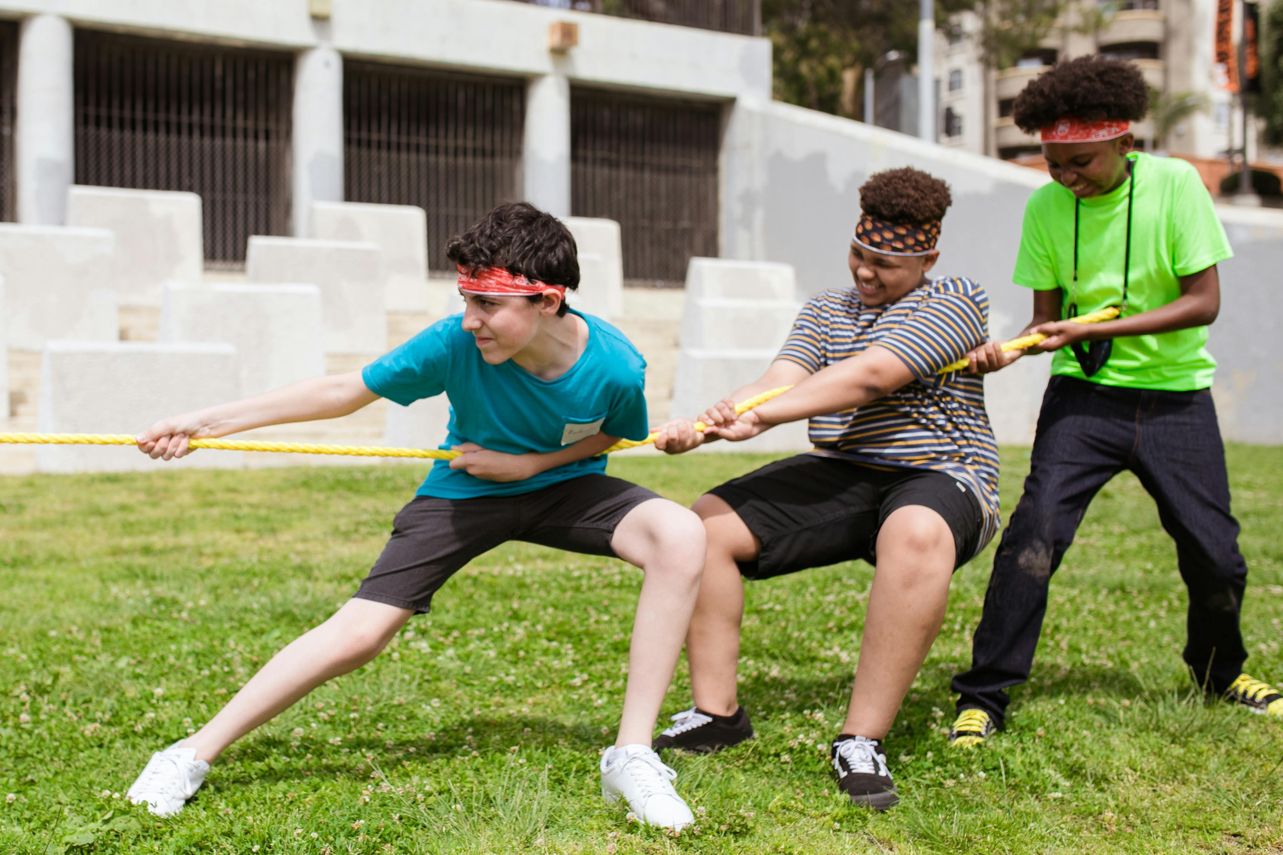 a group of boys playing a tug of war