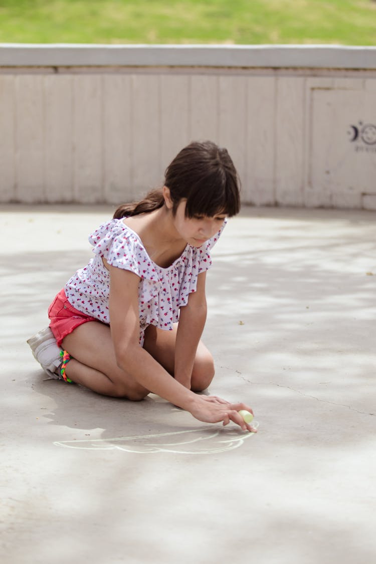 Girl Drawing On The Ground 