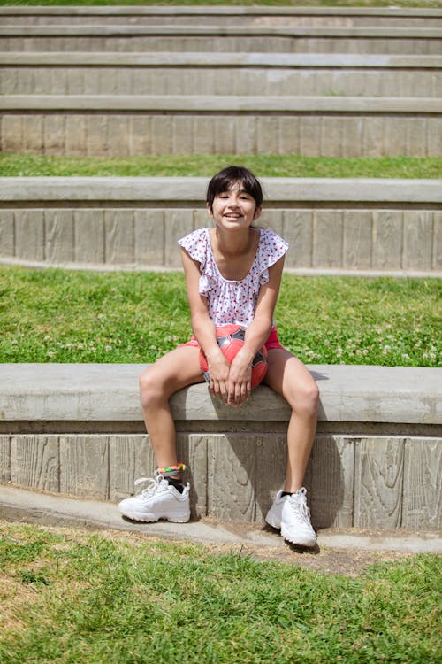 Free Girl Sitting on a Concrete Bench Stock Photo
