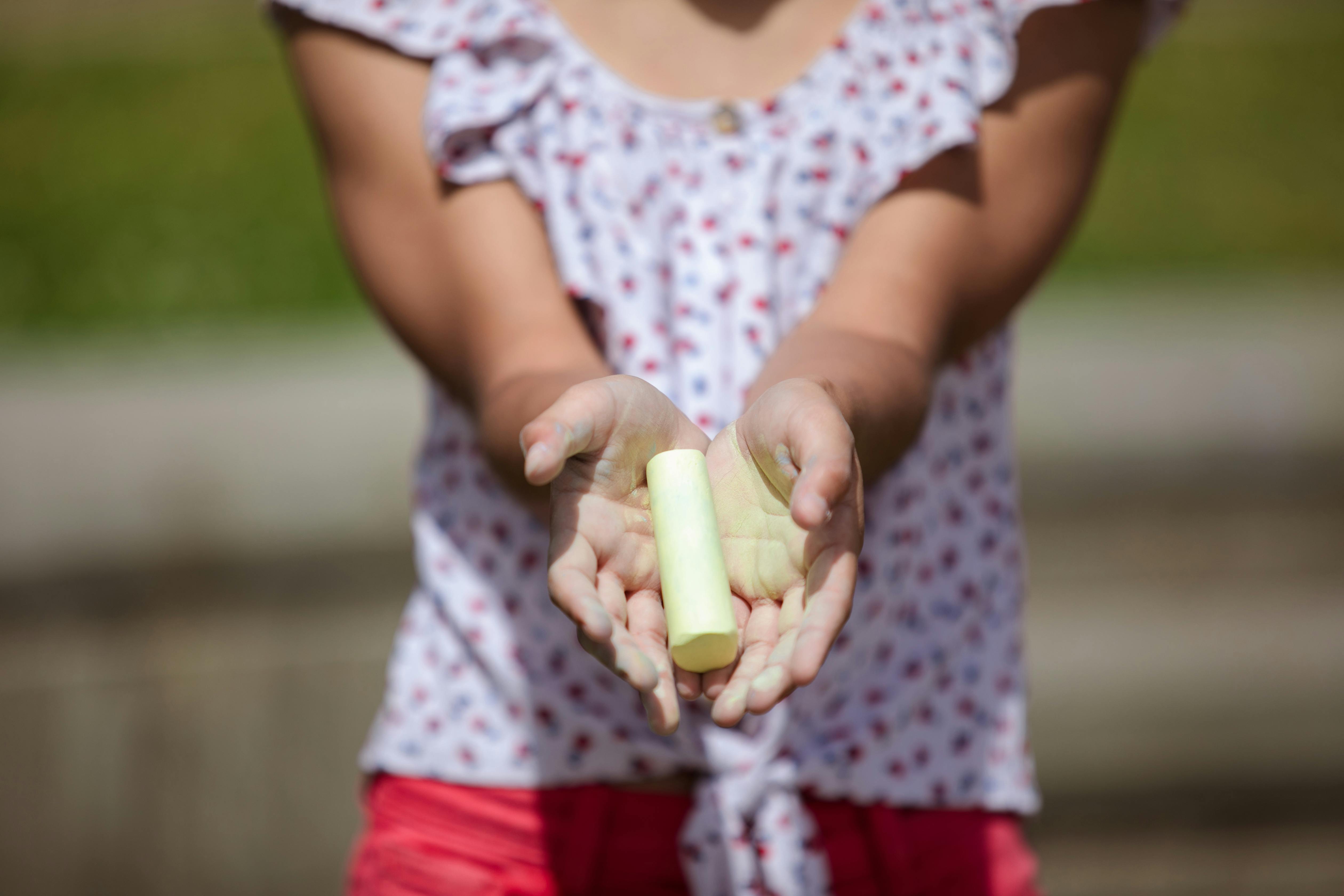 A Person Holding a Yellow Chalk · Free Stock Photo