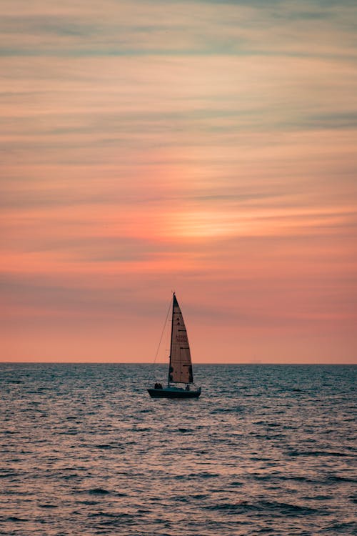 Free Boat on Ocean during Sunset Stock Photo