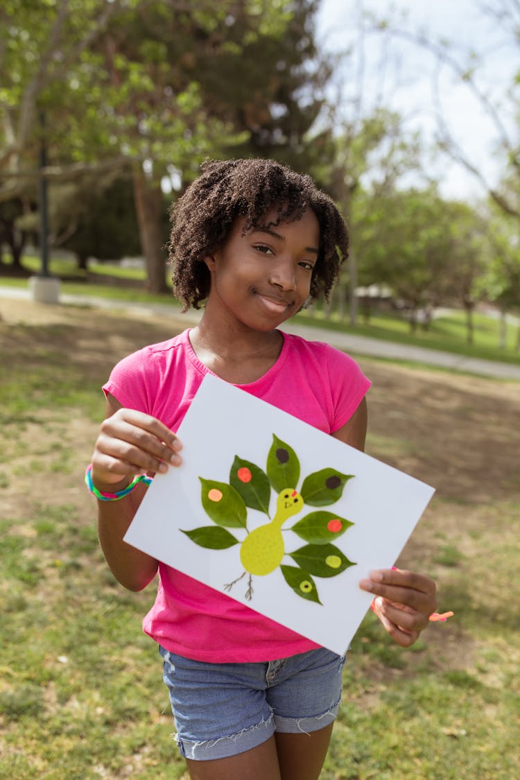 A Girl Holding An Artwork