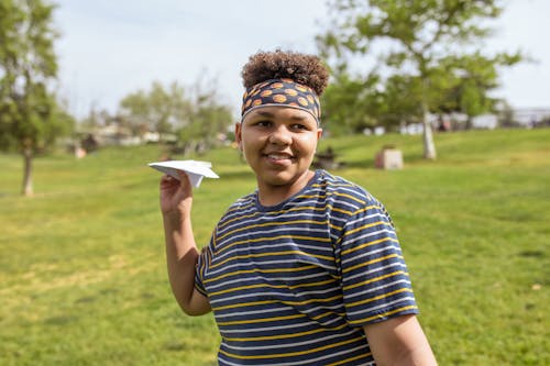 Boy Playing with Paper Plane
