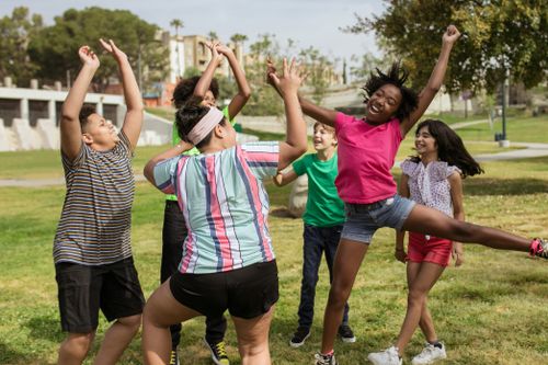 Free A group of children enjoying a sunny day in the park, full of laughter and playful energy. Stock Photo