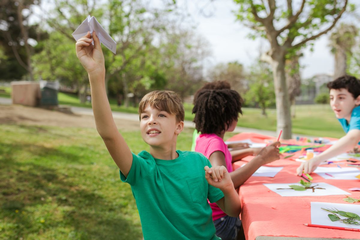 Campers laughing at a craft table