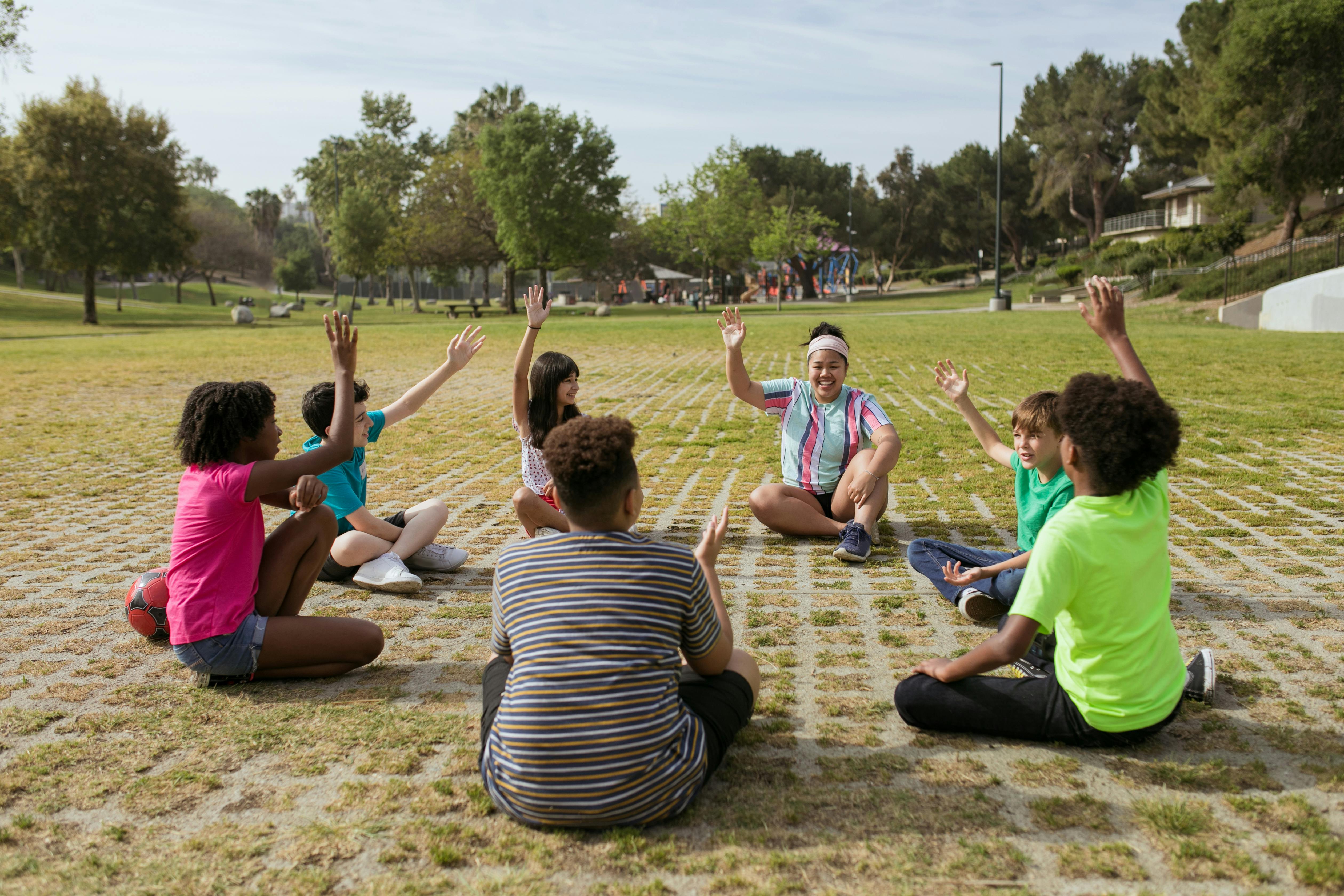 people sitting on brown sand