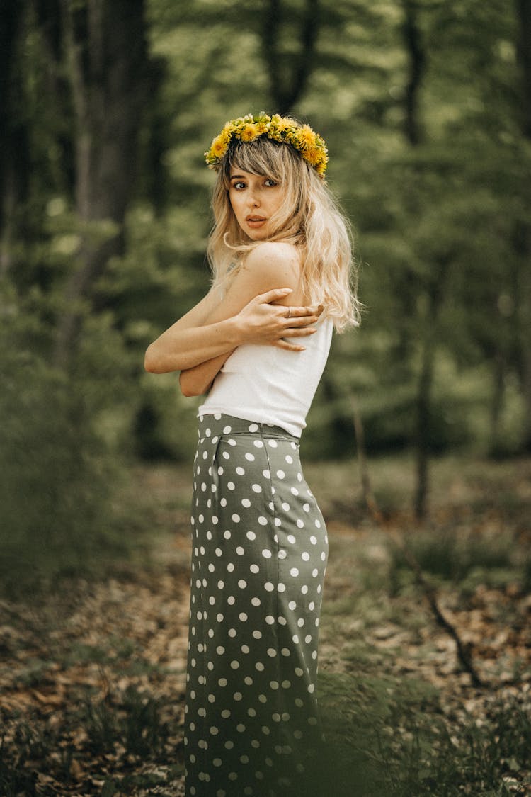 Young Woman With Yellow Dandelion Wreath On Head Embracing Herself