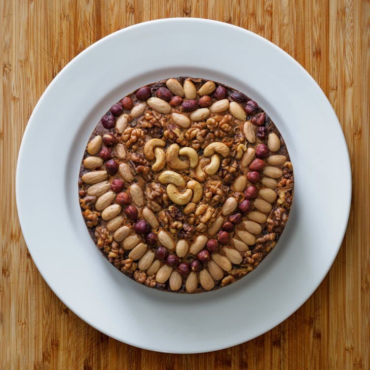 Round Cake With Nuts On White Ceramic Plate