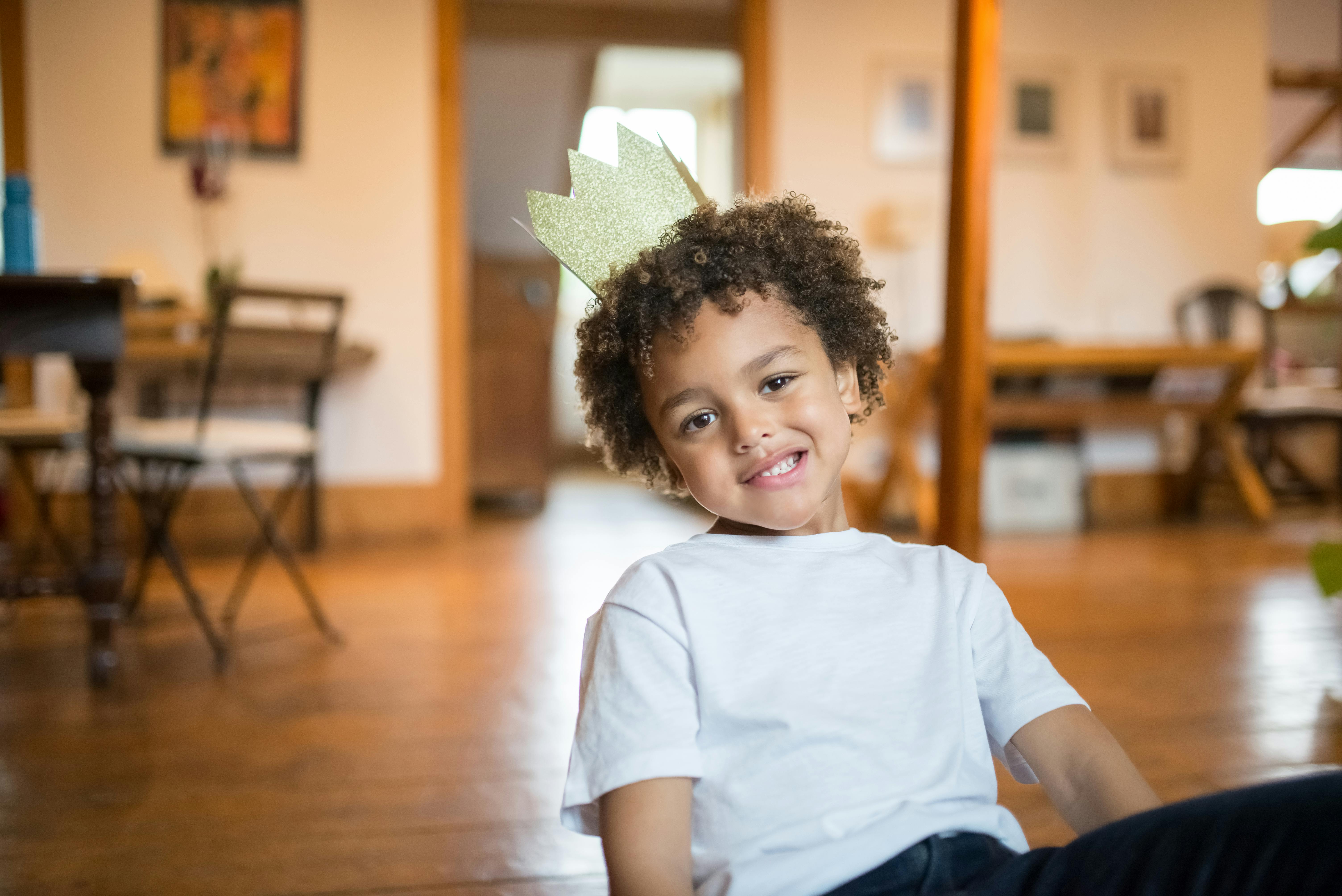 boy wearing a crown hat