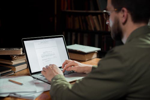 Man Typing on a Laptop 