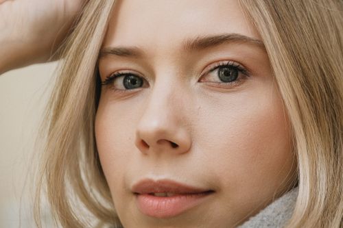 Free Intimate close-up of a woman's face highlighting natural beauty and expressive eyes. Stock Photo