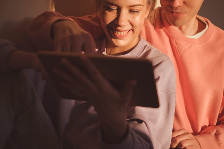 A Couple Watching On Digital Tablet