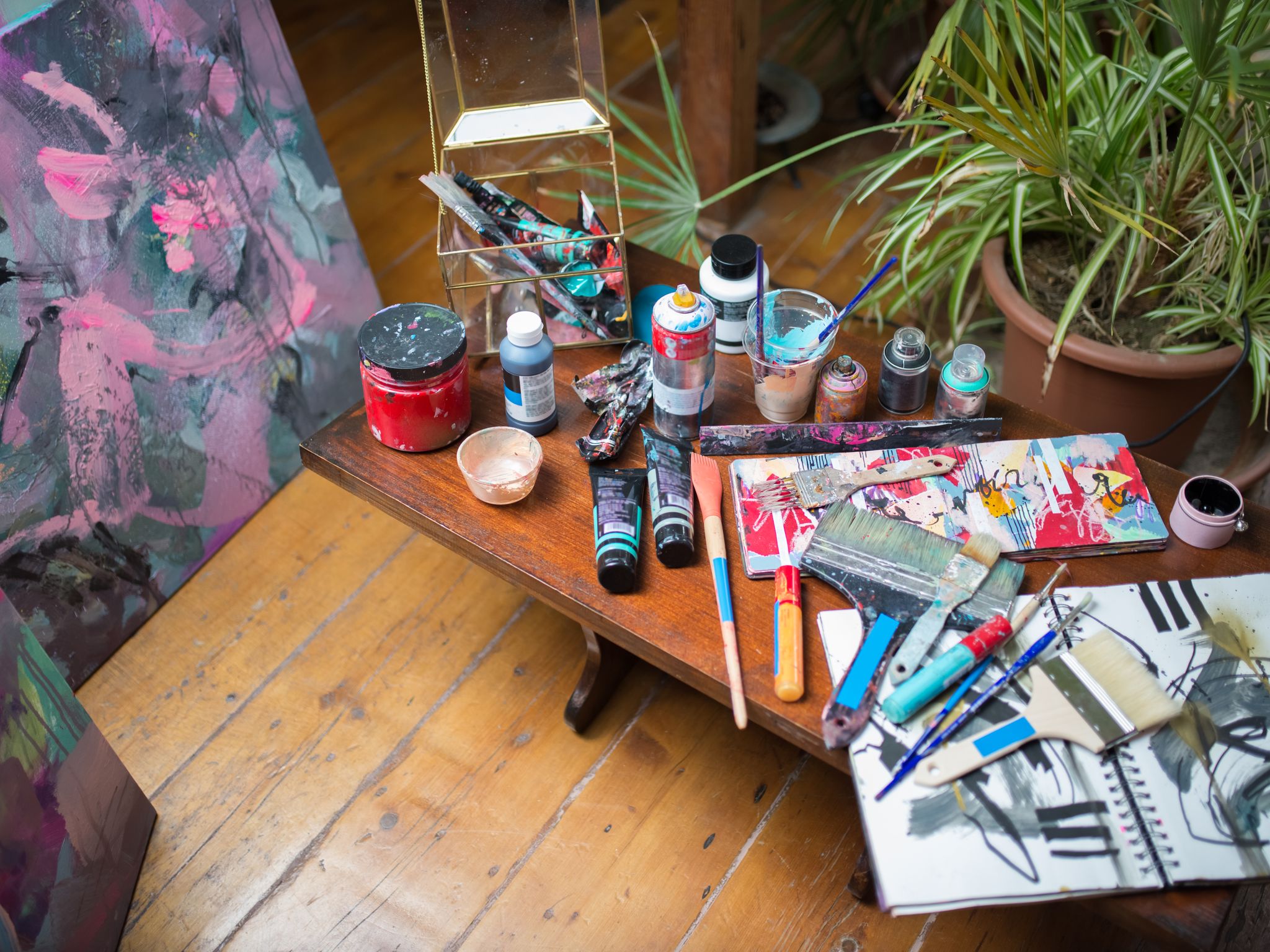 Artist working on a painting in a studio